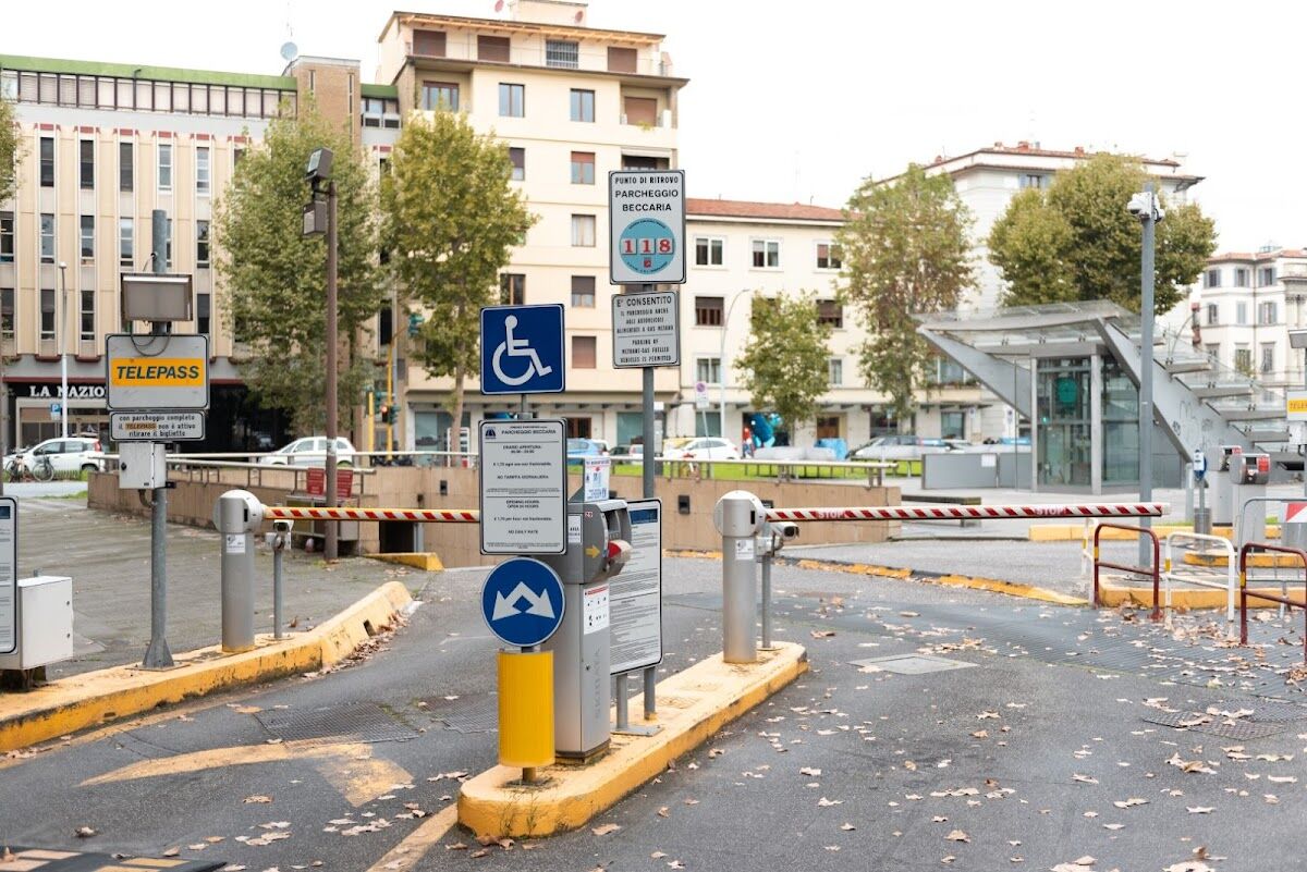 Parcheggio Beccaria: entrance with barrier gates, ticket machines and PARCHEGGIO BECCARIA sign in Piazza Beccaria