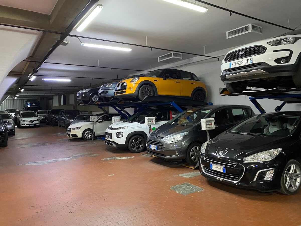 Cars parked on two-tier mechanical lifts inside the covered Garage Lungarno, Florence